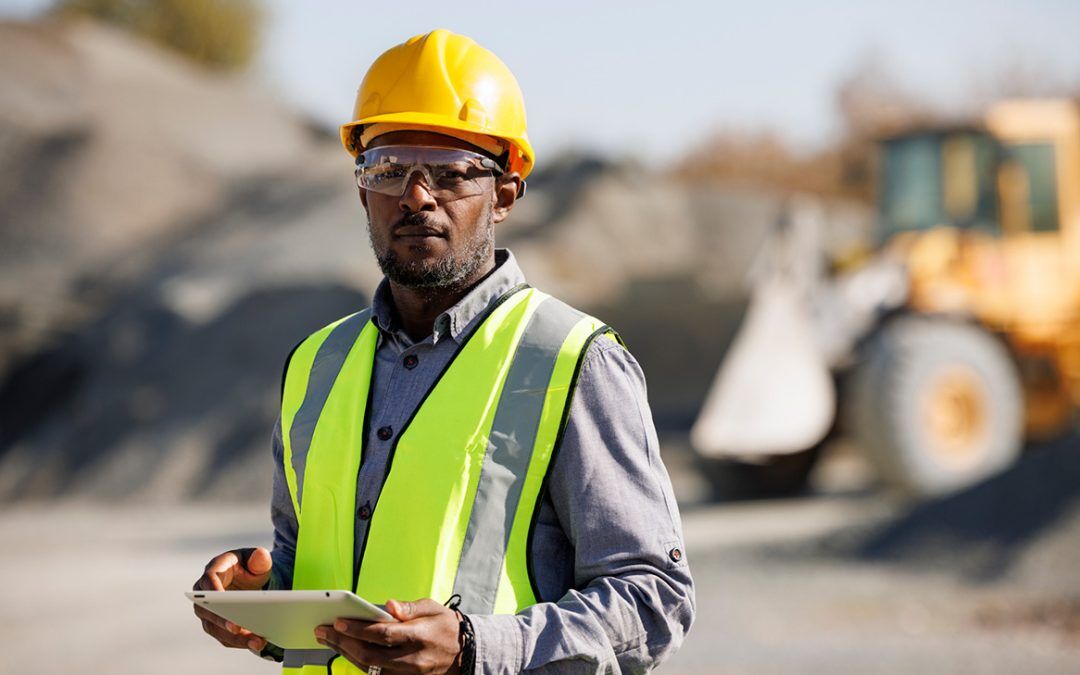 Portrait of male engineer with digital tablet for geographic information systems on right of way clearing and pipeline site